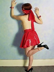 Beautiful girl in red rubber skirt and black corsette